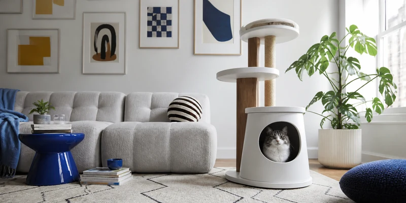 Modern sculptural cat tree in a bright apartment with blue accents